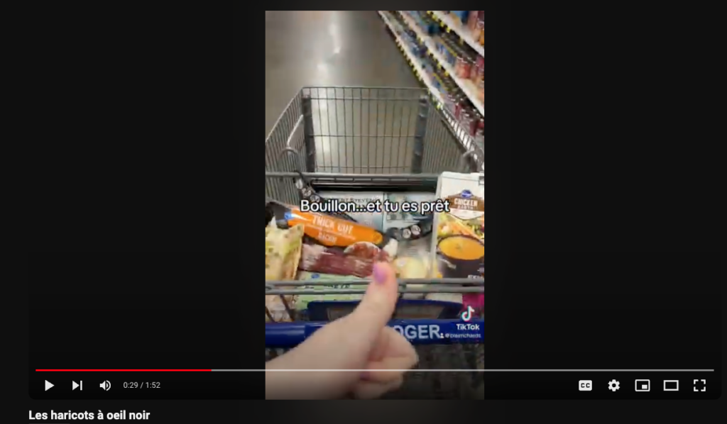 Picture 2 - The first-person point of view of my Black-eyed Peas TikTok - someone in a grocery store with stuff in a grocery cart and a thumbs up sign